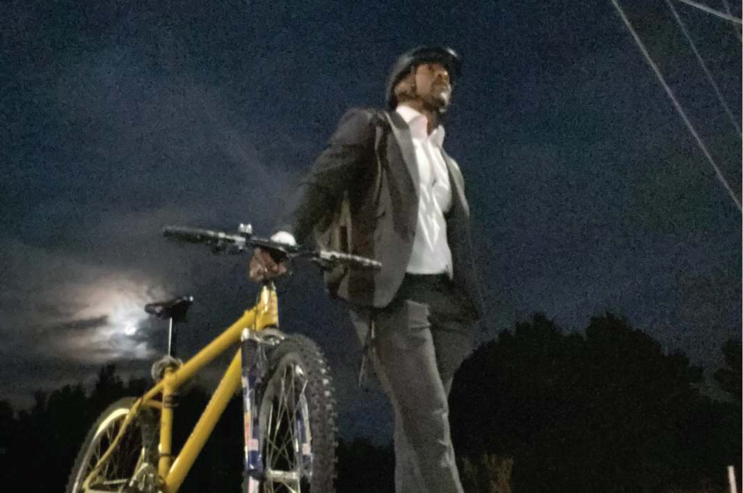 picture of Councillor Martin Reid holding e-bike and saying there is no bike war in Mississauga